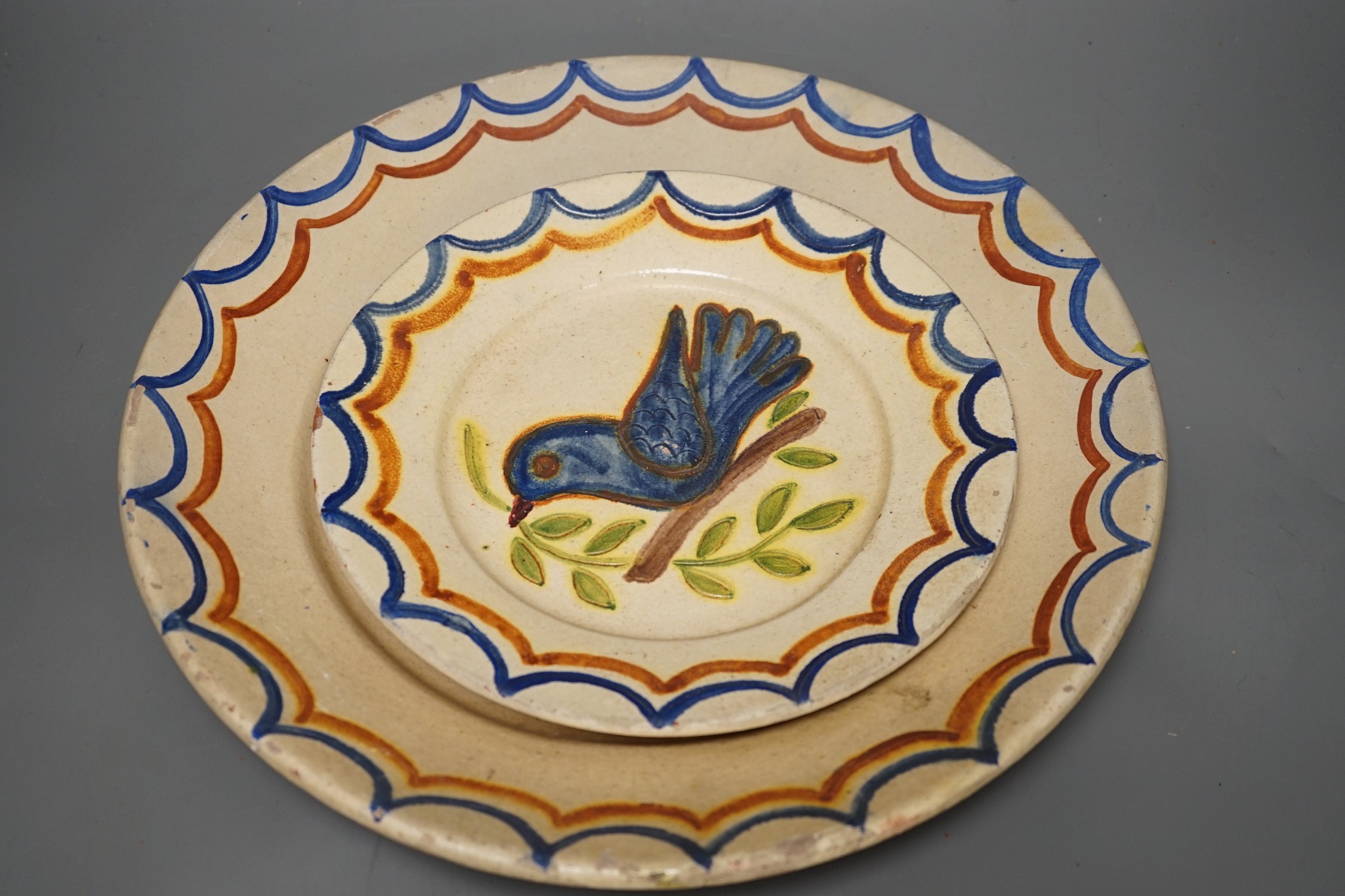 Five Portuguese provincial pottery plates, largest 35 cms diameter